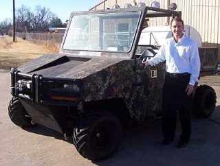 Revolution -- Robert Hall Jr., president of Hall Manufacturing of North Little Rock, stands with the prototype of the Bush-Whacker Revolution. The amphibious utility vehicle should cost around $17,900 for a basic package when released later this spring. (photo by Sitton)